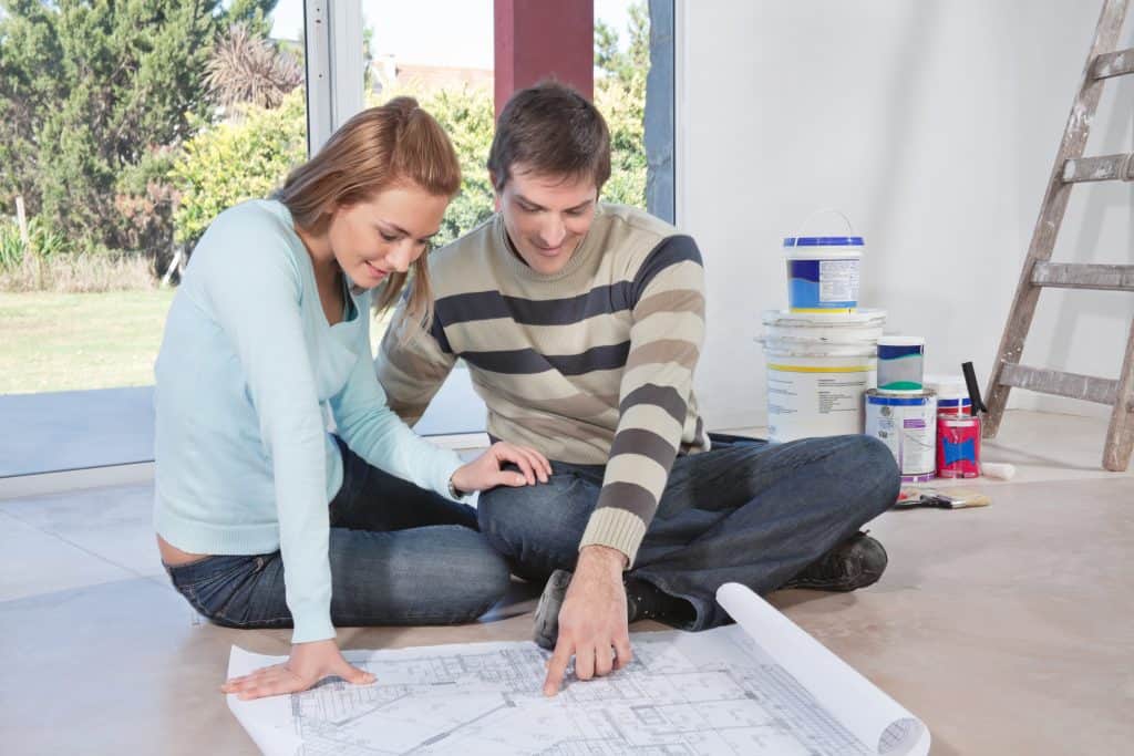 Couple looking at house plans to build their new home 
