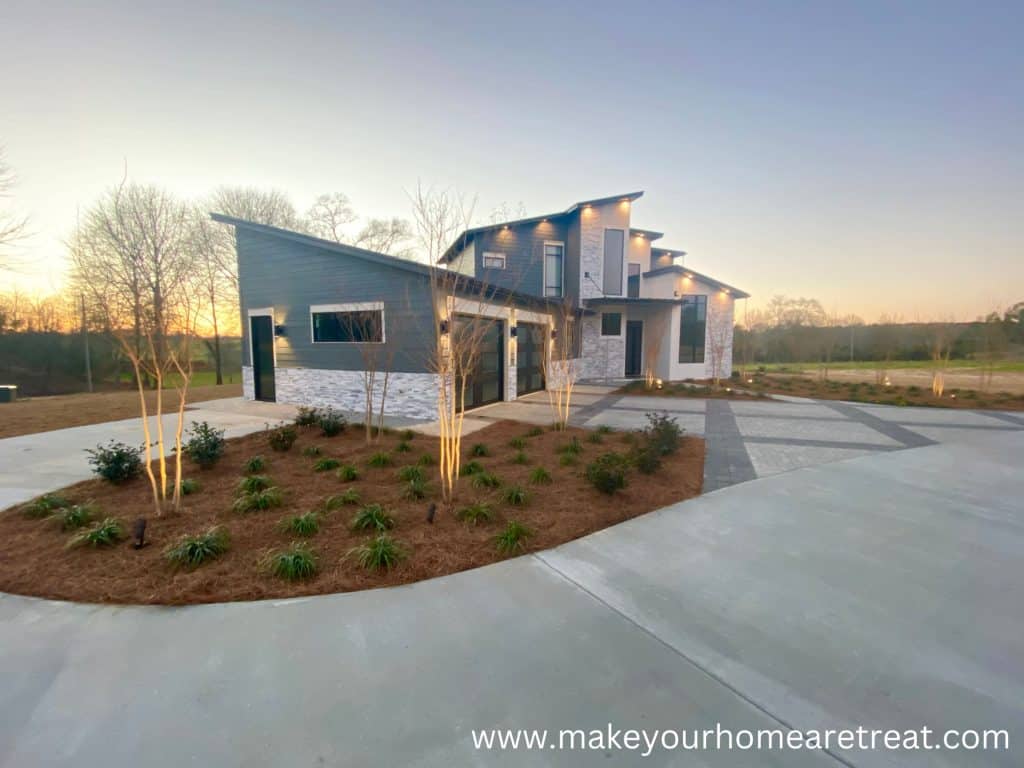Modern well lit home at sunset on a new lot.