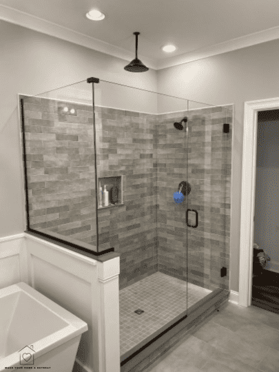 ceramic tile shower in a well lit bathroom.